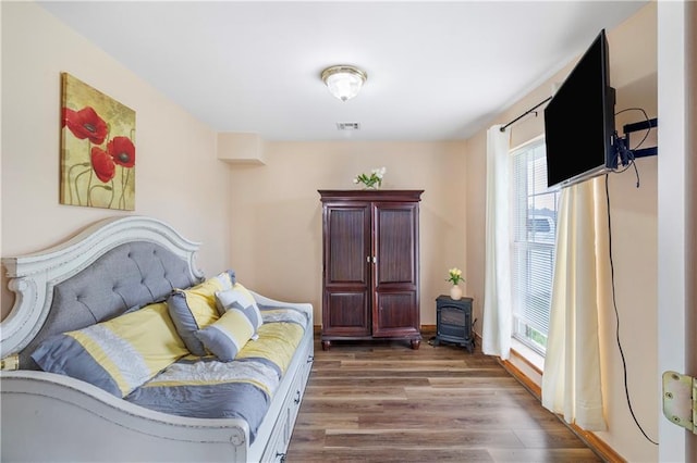 638 Colony Park Dr, La Place, LA 70068 - bedroom featuring wood finished floors and a wood stove