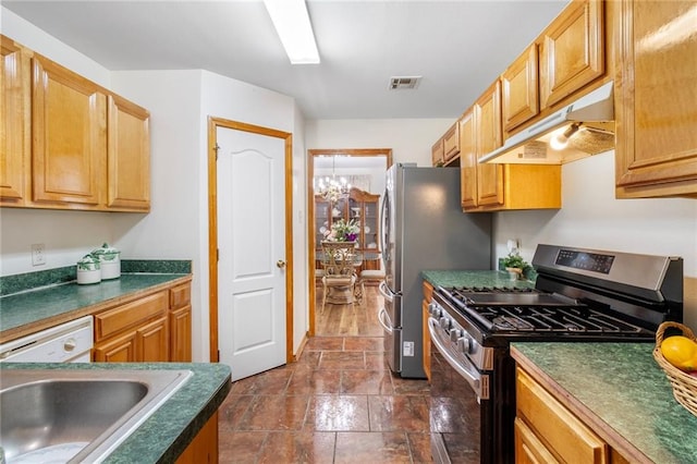 638 Colony Park Dr, La Place, LA 70068 - kitchen with stainless steel appliances, under cabinet range hood, dark countertops, and dark stone finish flooring