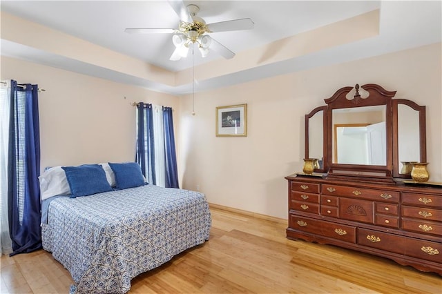 638 Colony Park Dr, La Place, LA 70068 - bedroom with light wood finished floors, a raised ceiling, and a ceiling fan
