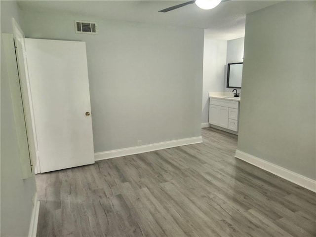 3320 N Arnoult Rd Unit 109, Metairie, LA 70002 - unfurnished bedroom with wood finished floors, ensuite bath, and ceiling fan