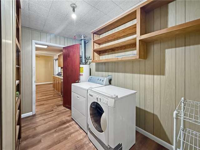 1593 Eastridge Dr, Slidell, LA 70458 - laundry area featuring washer and clothes dryer, wood walls, and light wood-style flooring