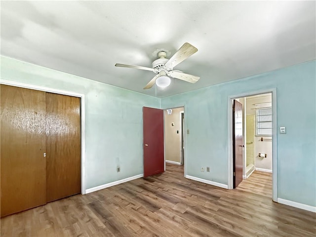 1593 Eastridge Dr, Slidell, LA 70458 - unfurnished bedroom with wood finished floors, a closet, connected bathroom, and ceiling fan