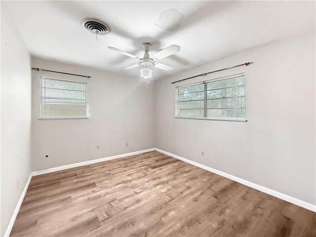 1593 Eastridge Dr, Slidell, LA 70458 - empty room with healthy amount of natural light, wood finished floors, and a ceiling fan