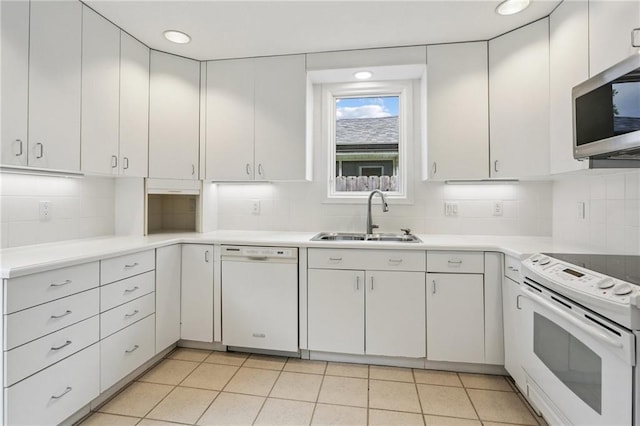 2310 Metairie Ct, Metairie, LA 70001 - kitchen with white appliances, tasteful backsplash, light countertops, white cabinetry, and recessed lighting