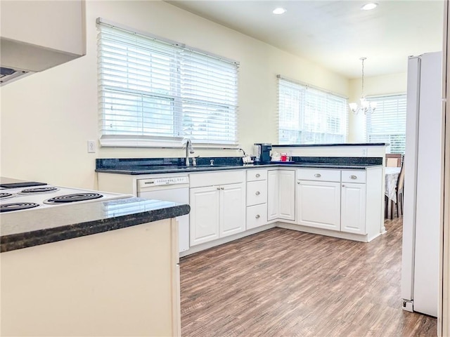 451 Sala Ave, Westwego, LA 70094 - kitchen with white appliances, a chandelier, white cabinetry, light wood-style floors, and recessed lighting
