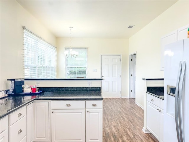 451 Sala Ave, Westwego, LA 70094 - kitchen with stainless steel fridge with ice dispenser, a chandelier, white cabinetry, and dark countertops