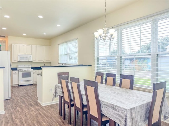 451 Sala Ave, Westwego, LA 70094 - dining space with a chandelier, wood finished floors, and recessed lighting