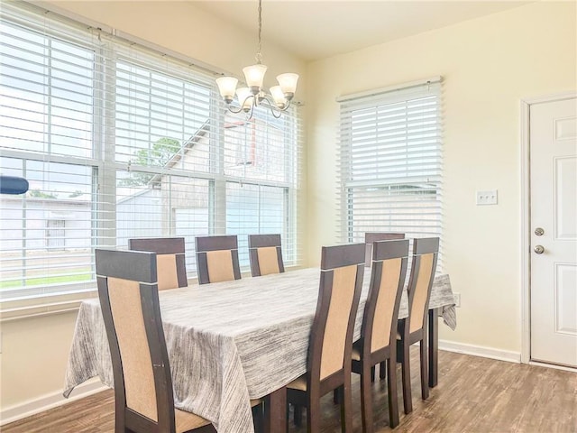 451 Sala Ave, Westwego, LA 70094 - dining space with a chandelier, plenty of natural light, and wood finished floors