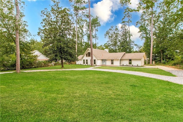 106 Woodlawn Ln, Mandeville, LA 70471 - view of front of home with curved driveway, a front yard, and a chimney