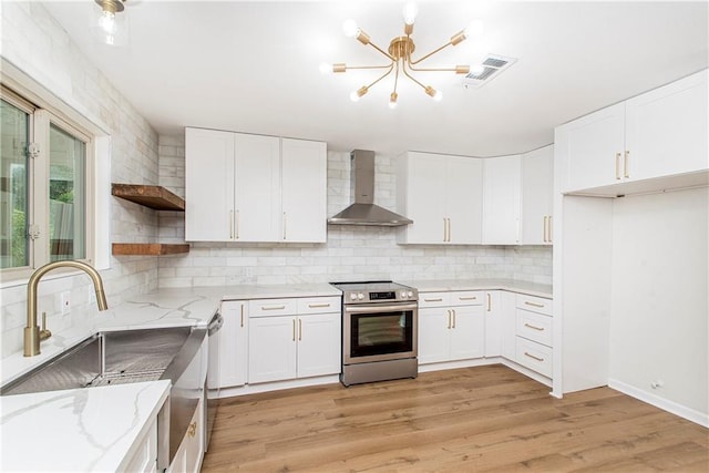 106 Woodlawn Ln, Mandeville, LA 70471 - kitchen featuring wall chimney exhaust hood, appliances with stainless steel finishes, open shelves, a chandelier, and decorative backsplash