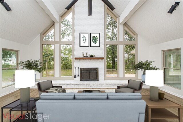 106 Woodlawn Ln, Mandeville, LA 70471 - living area with high vaulted ceiling, beam ceiling, wood finished floors, and a brick fireplace