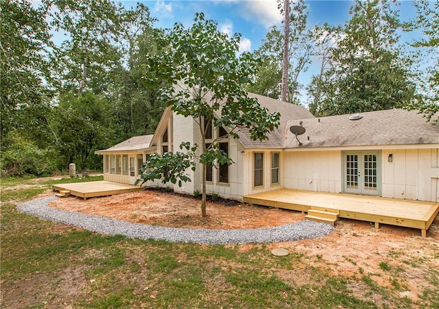 106 Woodlawn Ln, Mandeville, LA 70471 - back of property featuring french doors, a wooden deck, and a shingled roof