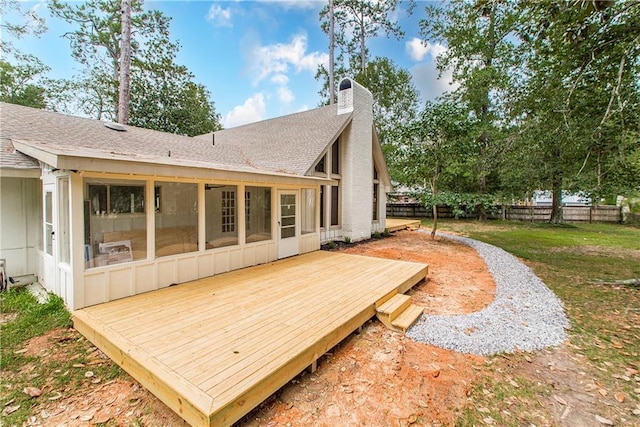 106 Woodlawn Ln, Mandeville, LA 70471 - rear view of house with a sunroom, a chimney, roof with shingles, and a deck