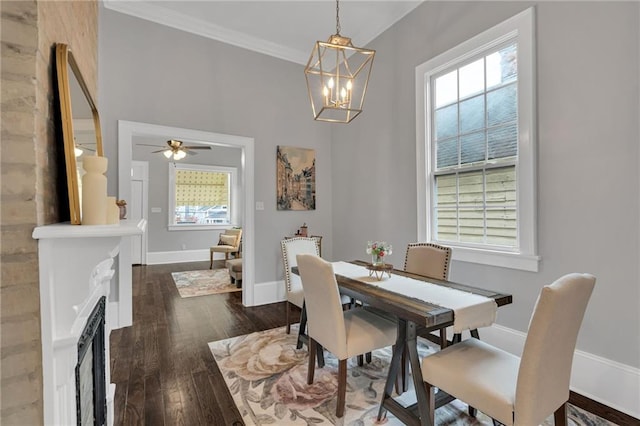 2625 Ursulines Ave, New Orleans, LA 70119 - dining area featuring dark wood-style floors, a chandelier, a fireplace, ceiling fan, and ornamental molding