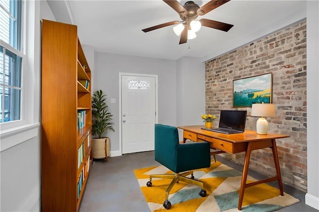 2625 Ursulines Ave, New Orleans, LA 70119 - office with ceiling fan, brick wall, and concrete flooring