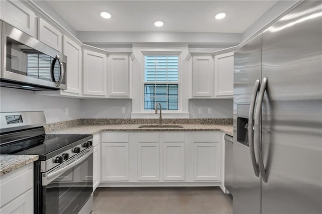 2625 Ursulines Ave, New Orleans, LA 70119 - kitchen with stainless steel appliances, white cabinets, light stone countertops, and recessed lighting
