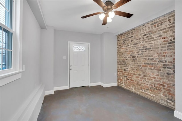2625 Ursulines Ave, New Orleans, LA 70119 - entryway with brick wall, concrete floors, and ceiling fan