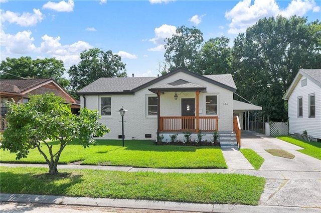 566 Gelpi Ave, Jefferson, LA 70121 - bungalow-style house featuring concrete driveway, a front lawn, covered porch, brick siding, and an attached carport
