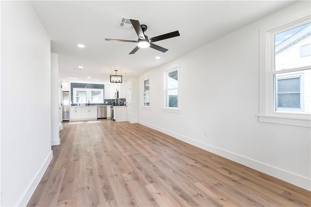 566 Gelpi Ave, Jefferson, LA 70121 - unfurnished living room with light wood-type flooring, a ceiling fan, recessed lighting, and plenty of natural light