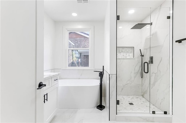 566 Gelpi Ave, Jefferson, LA 70121 - full bath featuring marble look tiles, a marble finish shower, a soaking tub, vanity, and recessed lighting