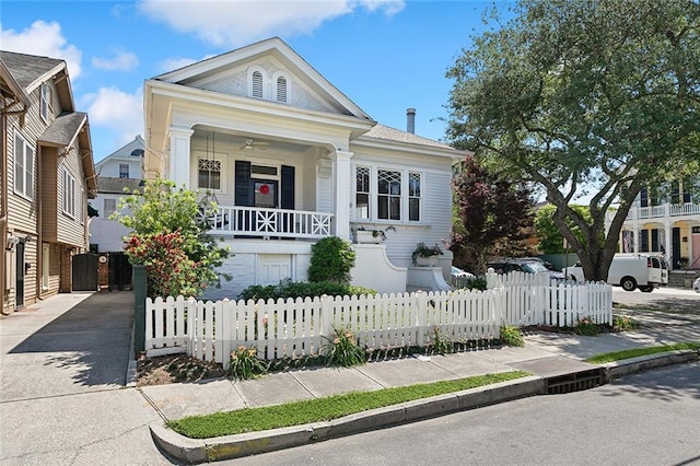 5540 Pitt St, New Orleans, LA 70115 - view of front of house with concrete driveway, a porch, and a fenced front yard