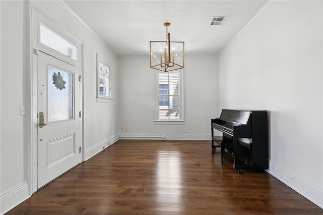5540 Pitt St, New Orleans, LA 70115 - foyer with ornamental molding, dark wood-style floors, and a chandelier
