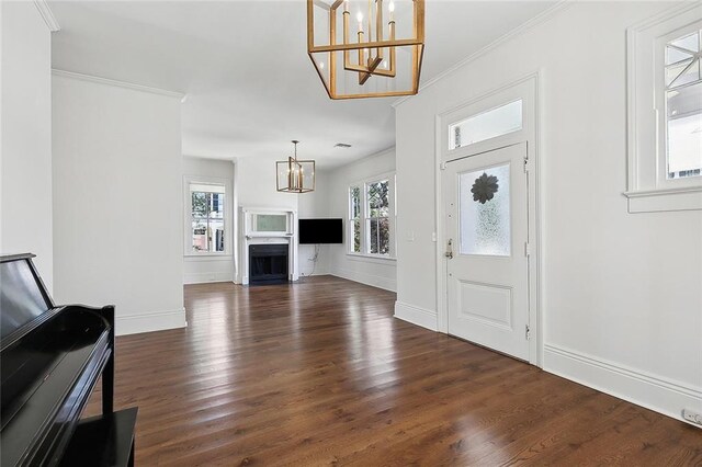 5540 Pitt St, New Orleans, LA 70115 - foyer entrance featuring a chandelier, dark wood-type flooring, and ornamental molding