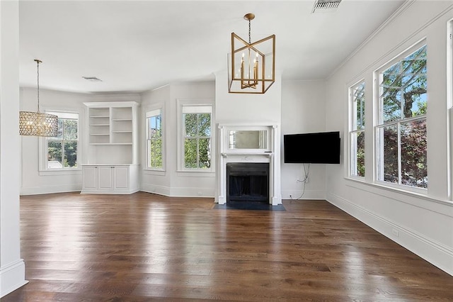 5540 Pitt St, New Orleans, LA 70115 - unfurnished living room with a chandelier, dark wood-type flooring, and a fireplace with flush hearth