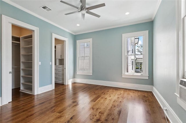 5540 Pitt St, New Orleans, LA 70115 - unfurnished bedroom featuring a walk in closet, wood finished floors, ornamental molding, recessed lighting, and a closet
