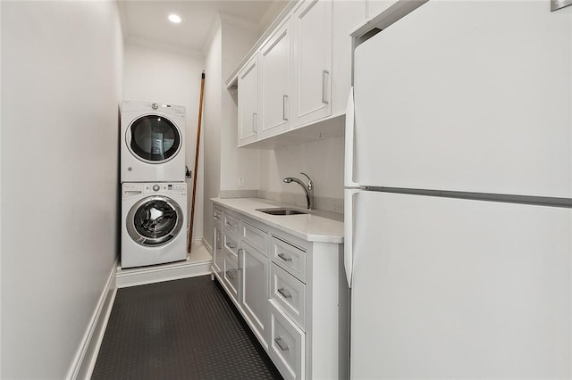 5540 Pitt St, New Orleans, LA 70115 - washroom featuring stacked washer and clothes dryer, ornamental molding, and recessed lighting