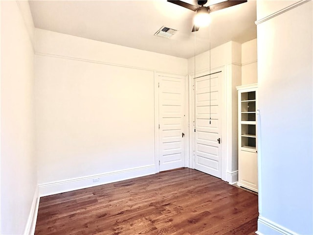 5540 Pitt St, New Orleans, LA 70115 - unfurnished bedroom with dark wood-style floors, a closet, and a ceiling fan