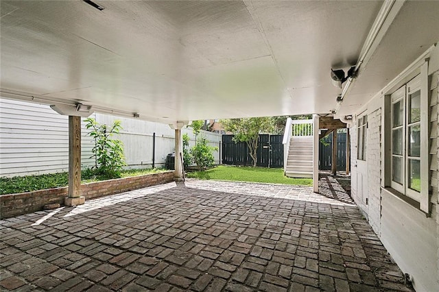 5540 Pitt St, New Orleans, LA 70115 - fenced backyard with stairway and a patio area