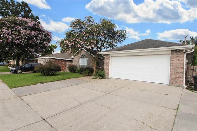 345 Sugarpine Dr, Gretna, LA 70056 - ranch-style house featuring driveway, brick siding, a front yard, and an attached garage