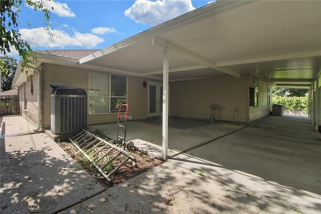 345 Sugarpine Dr, Gretna, LA 70056 - view of patio with an attached carport and driveway