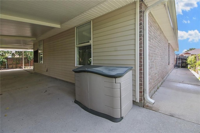 345 Sugarpine Dr, Gretna, LA 70056 - view of patio with an attached carport