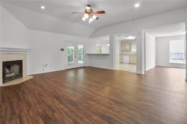 345 Sugarpine Dr, Gretna, LA 70056 - unfurnished living room featuring ceiling fan, wood finished floors, a tiled fireplace, french doors, and lofted ceiling