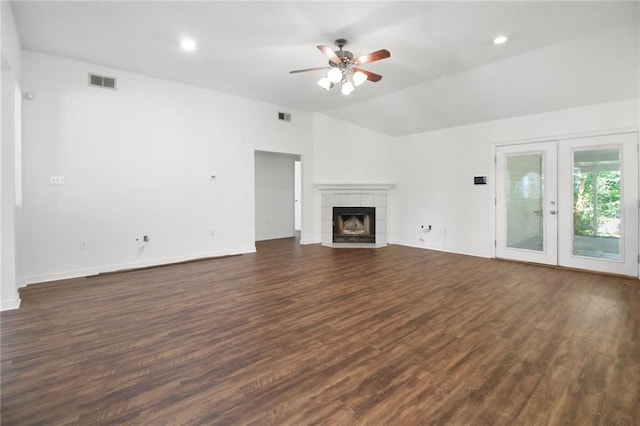 345 Sugarpine Dr, Gretna, LA 70056 - unfurnished living room with a ceiling fan, lofted ceiling, dark wood finished floors, a tile fireplace, and french doors