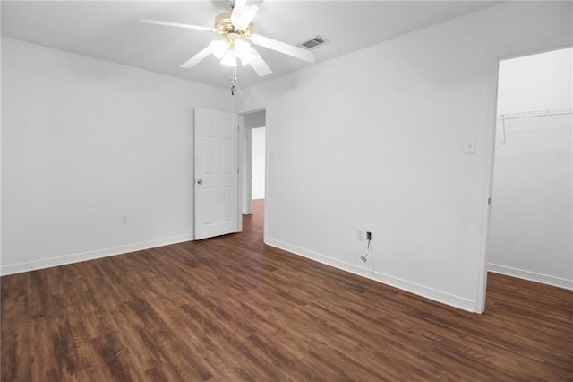 345 Sugarpine Dr, Gretna, LA 70056 - unfurnished bedroom with dark wood-style flooring, a closet, a walk in closet, and ceiling fan