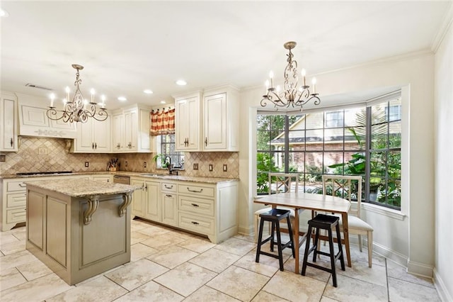 201 Shaunell Dr, Mandeville, LA 70448 - kitchen with a chandelier, tasteful backsplash, appliances with stainless steel finishes, light stone counters, and ornamental molding