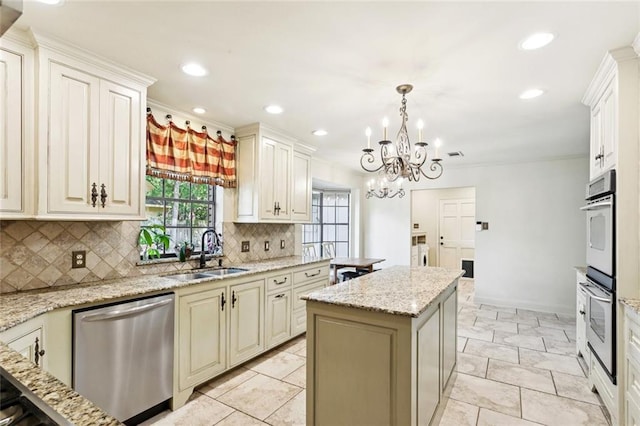 201 Shaunell Dr, Mandeville, LA 70448 - kitchen with stainless steel appliances, a center island, a chandelier, tasteful backsplash, and recessed lighting