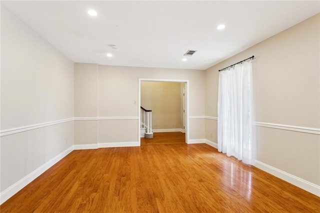 201 Shaunell Dr, Mandeville, LA 70448 - spare room with wood finished floors, stairs, and recessed lighting