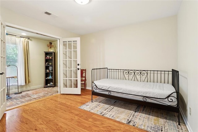 201 Shaunell Dr, Mandeville, LA 70448 - bedroom with french doors and wood finished floors