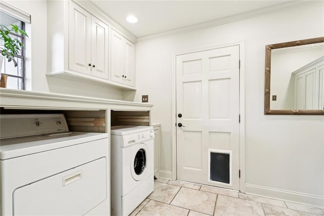 201 Shaunell Dr, Mandeville, LA 70448 - laundry area with washer and dryer, ornamental molding, cabinet space, and light tile patterned floors