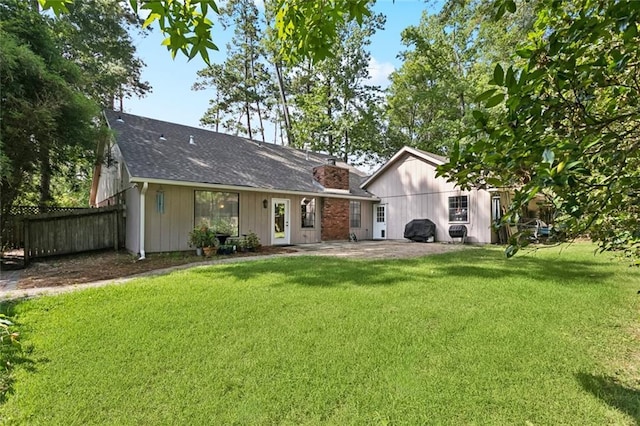 201 Shaunell Dr, Mandeville, LA 70448 - rear view of house with a chimney, a patio area, and roof with shingles
