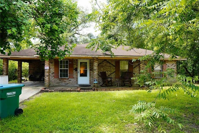 110 E Green St, Hammond, LA 70403 - view of front of property with covered porch, a front yard, and brick siding