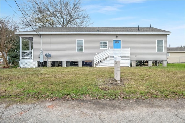 6501 Selma St, New Orleans, LA 70126 - back of house featuring a lawn and roof with shingles