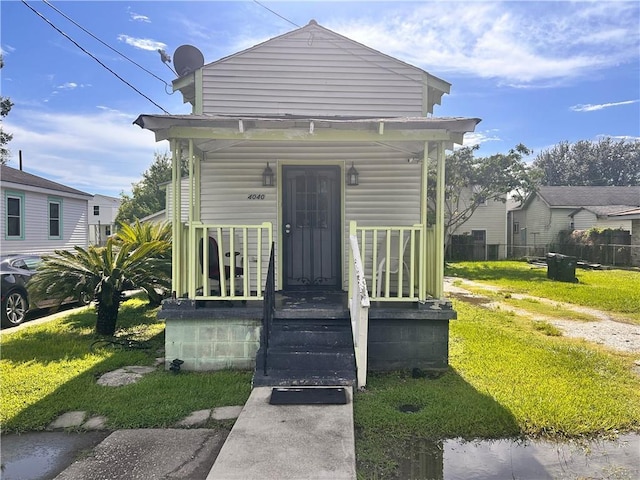 4040 Velie St, New Orleans, LA 70126 - shotgun-style home featuring a porch