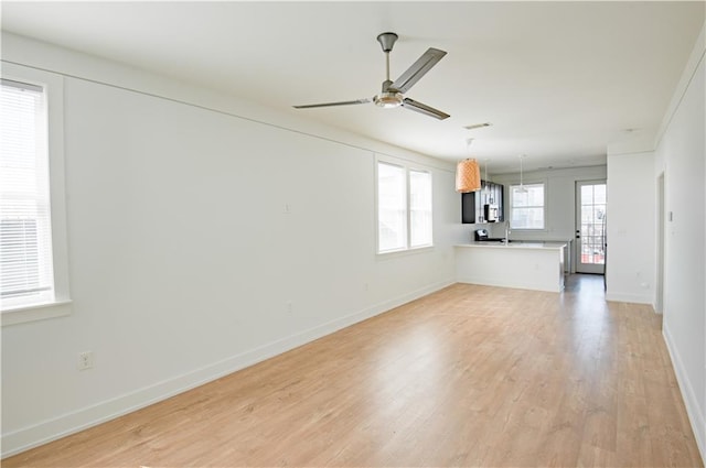 414345 Ulloa St, New Orleans, LA 70119 - unfurnished living room featuring ceiling fan and light wood-style flooring