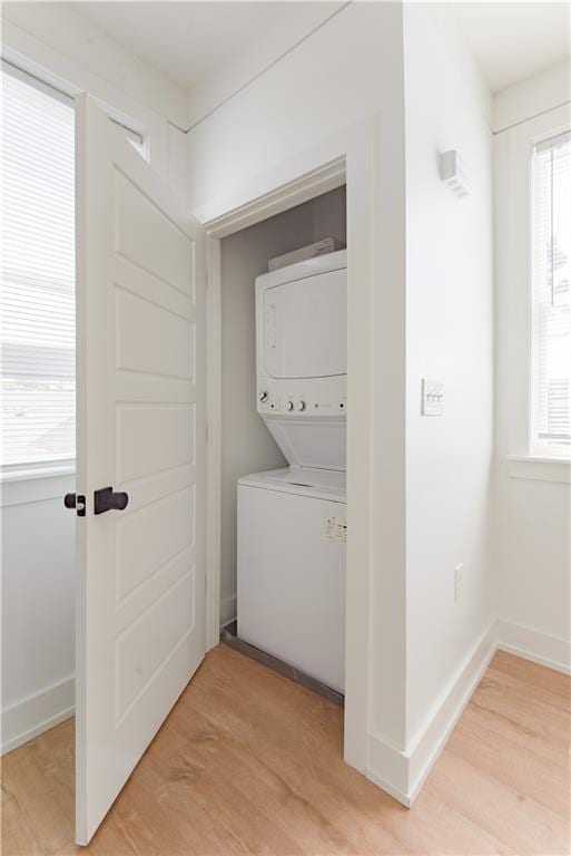 414345 Ulloa St, New Orleans, LA 70119 - laundry room featuring estacked washer and dryer and light wood finished floors