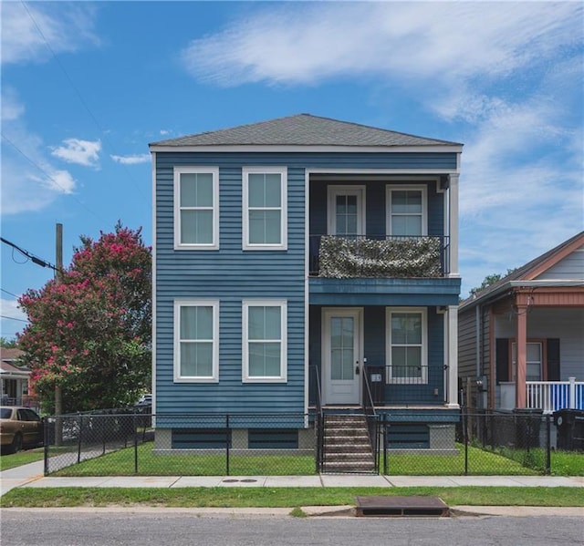 414345 Ulloa St, New Orleans, LA 70119 - view of front facade featuring a porch, a balcony, a fenced front yard, and a gate